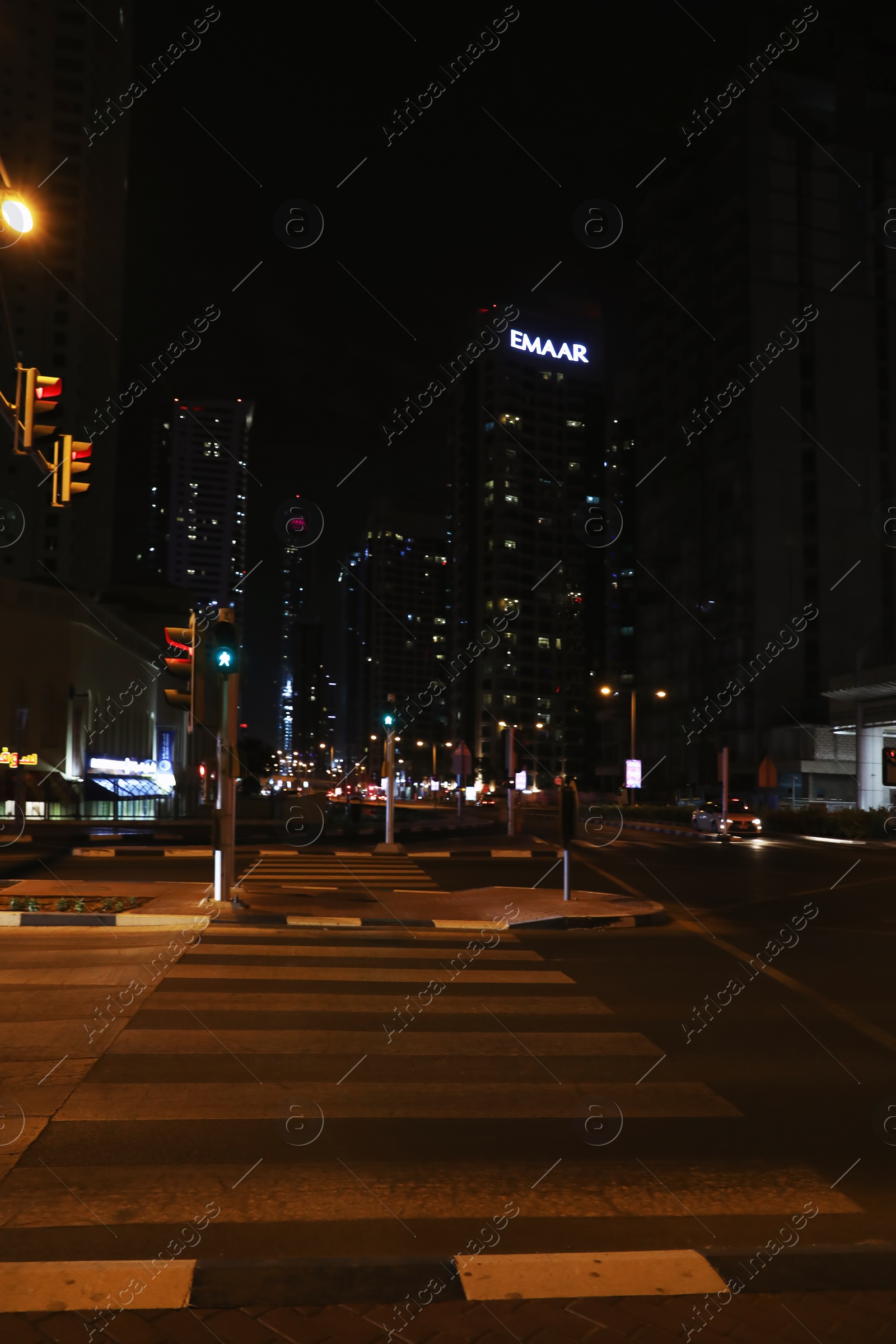 Photo of DUBAI, UNITED ARAB EMIRATES - NOVEMBER 03, 2018: Night cityscape with crosswalk and illuminated buildings