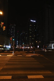 Photo of DUBAI, UNITED ARAB EMIRATES - NOVEMBER 03, 2018: Night cityscape with crosswalk and illuminated buildings