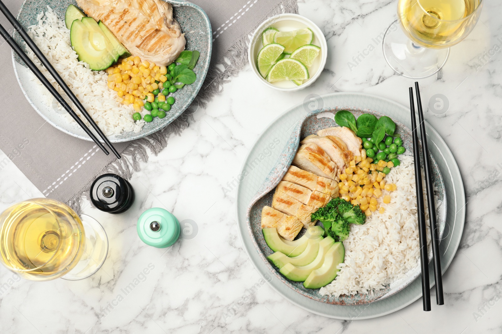 Photo of Boiled rice with vegetables and meat served on marble table, flat lay