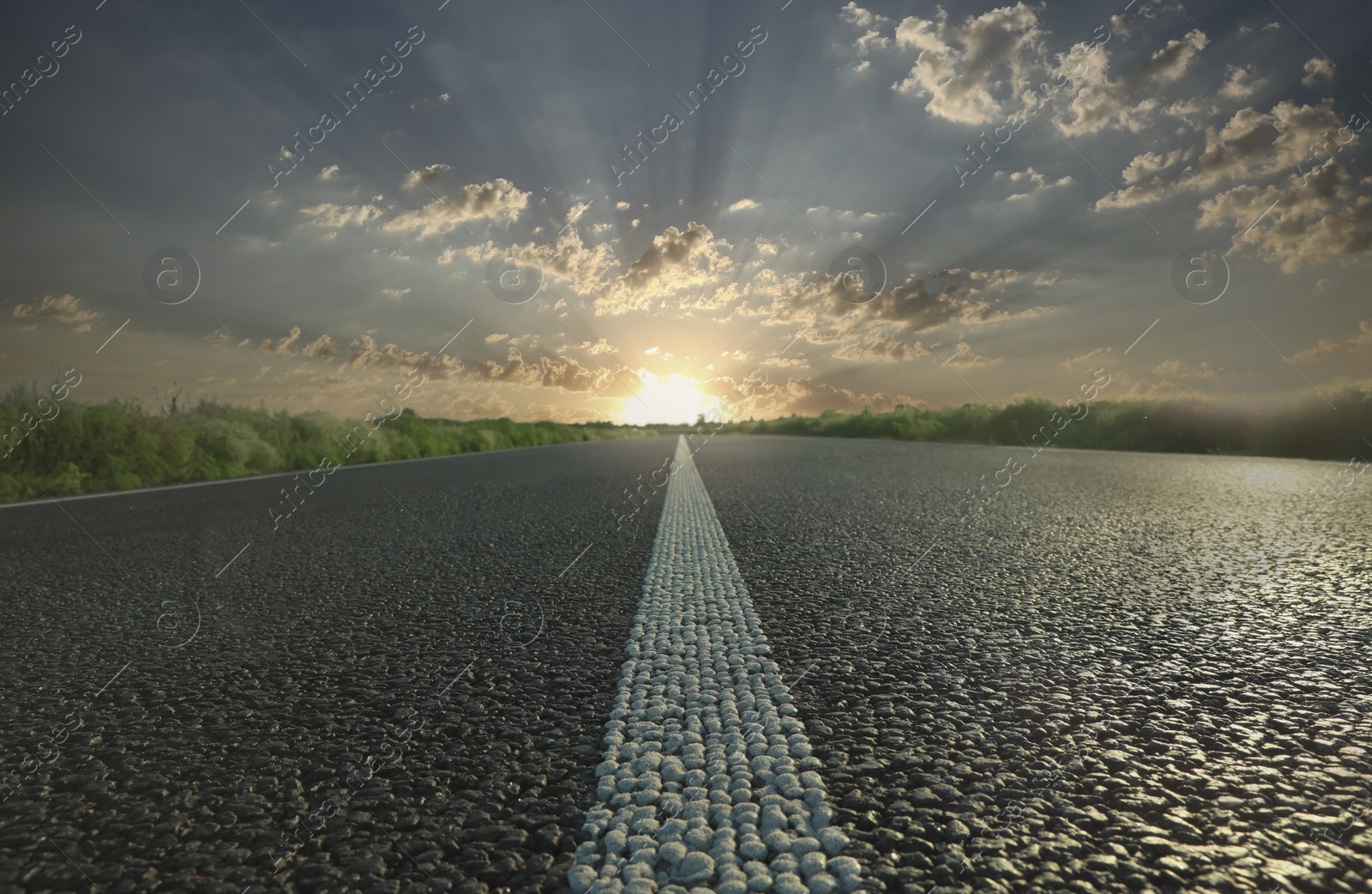 Image of Empty asphalt road at sunrise, closeup view