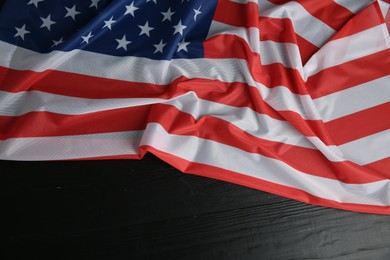 Photo of Flag of USA on black wooden table, top view