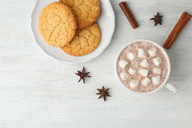 Photo of Composition with delicious hot cocoa drink and cookies on white wooden background, flat lay