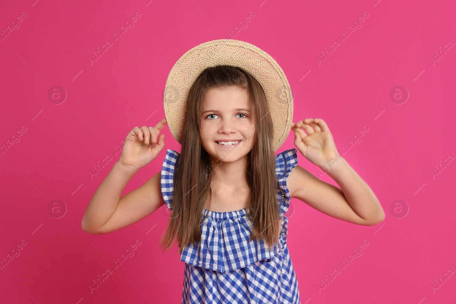 Photo of Portrait of preteen girl in hat on pink background