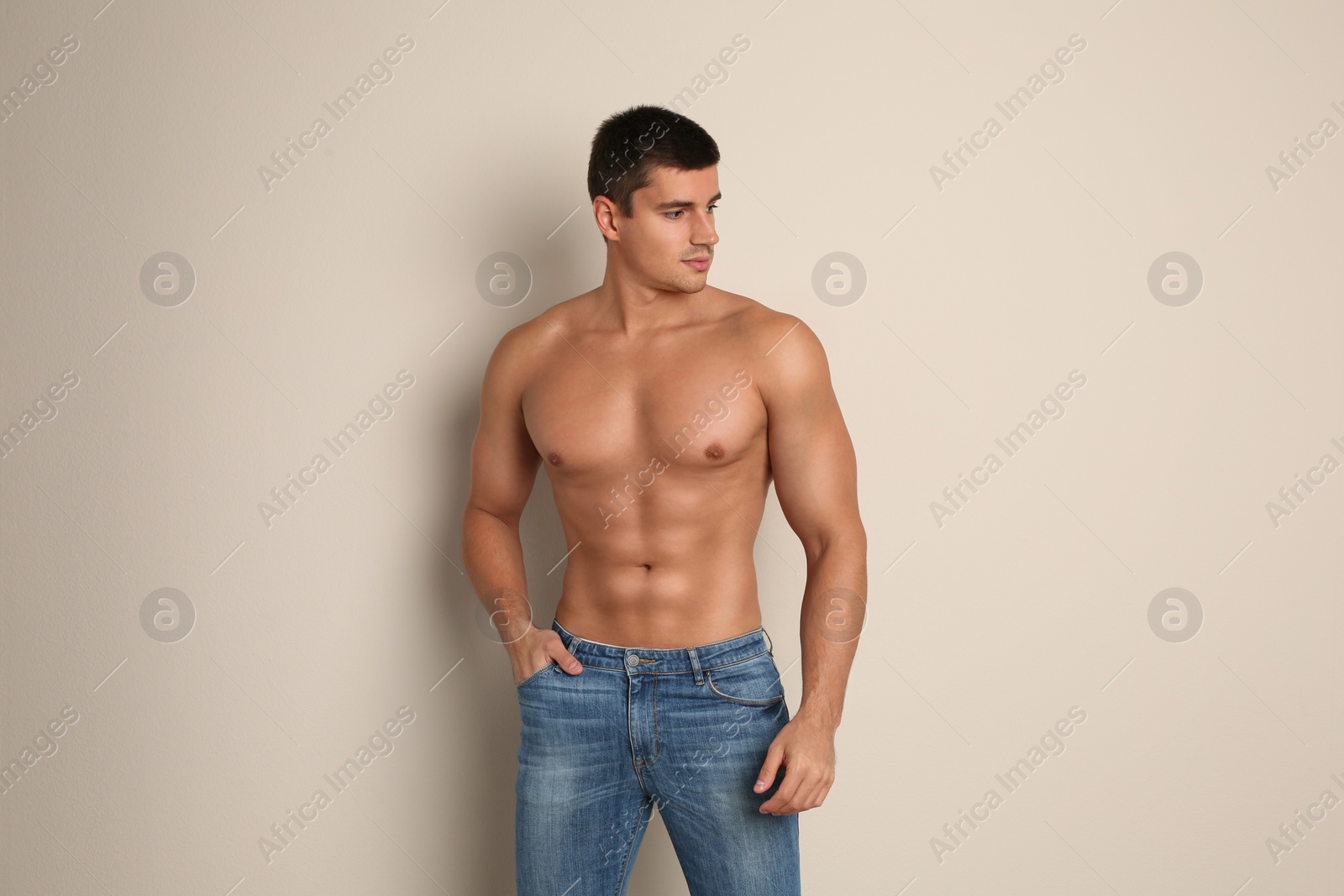 Photo of Man with sexy body on beige background