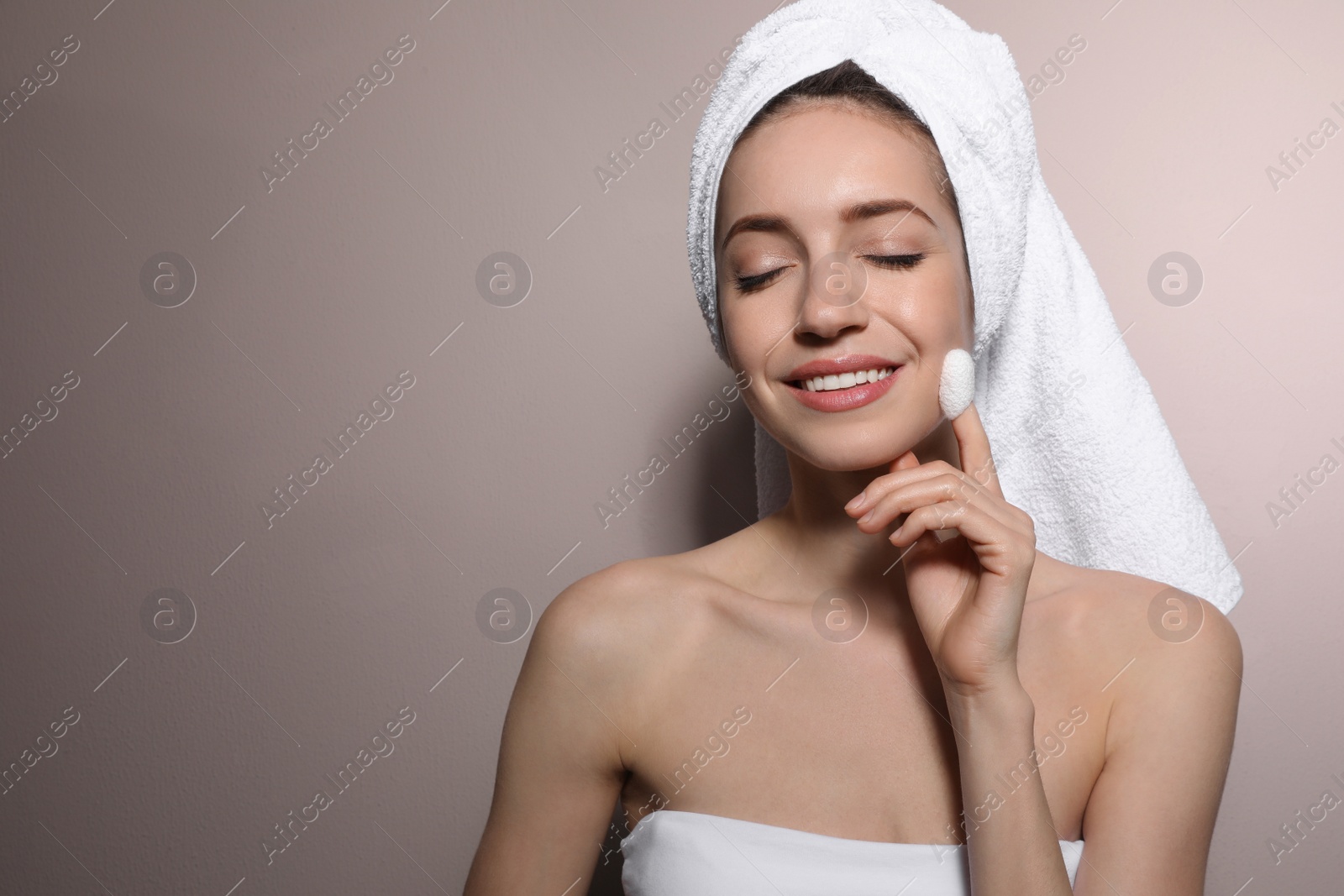 Photo of Woman using silkworm cocoon in skin care routine on light grey background. Space for text