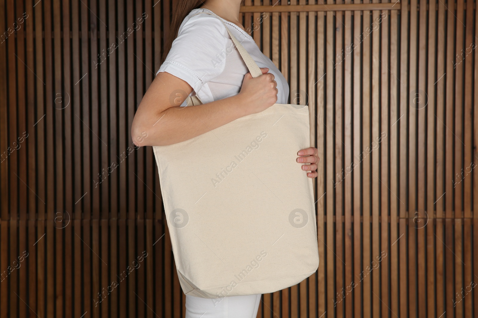 Photo of Woman with eco bag on wooden background. Mock up for design