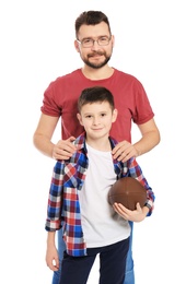 Little boy and his dad with ball on white background