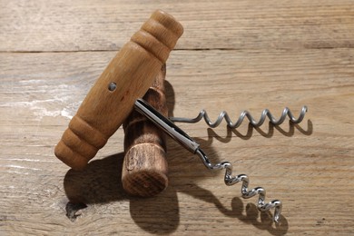 Two different corkscrews on wooden table. Kitchen utensil