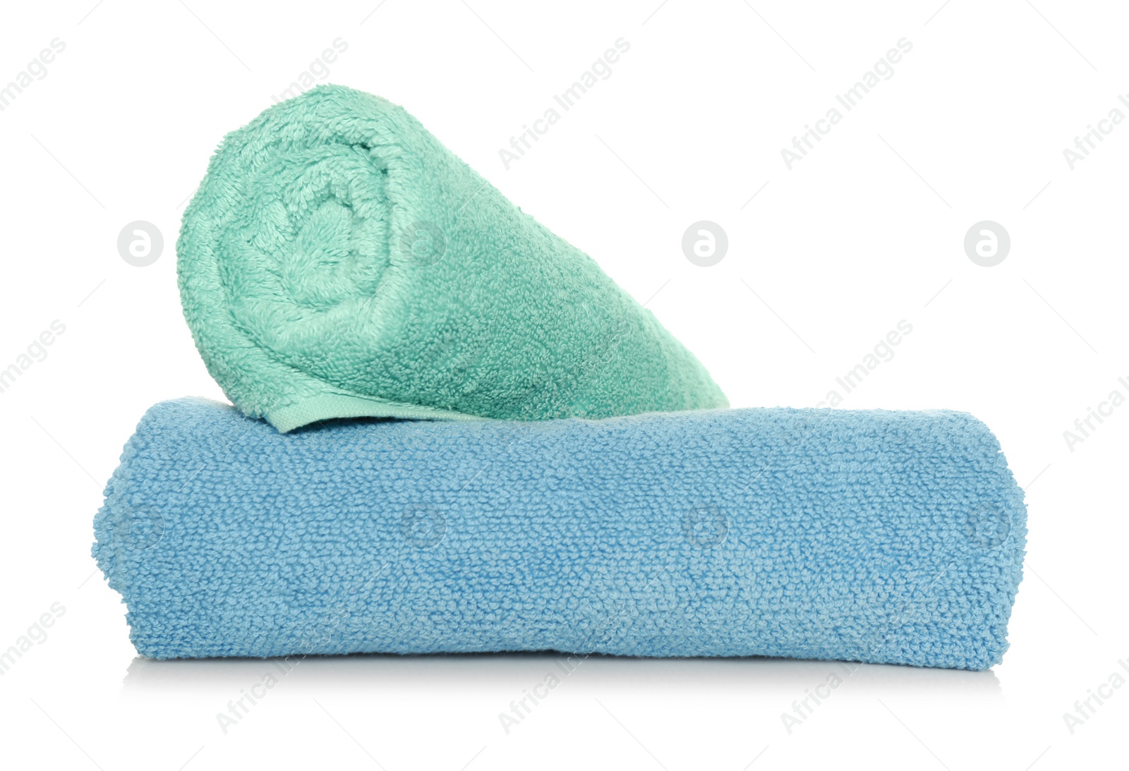 Photo of Rolled soft terry towels on white background