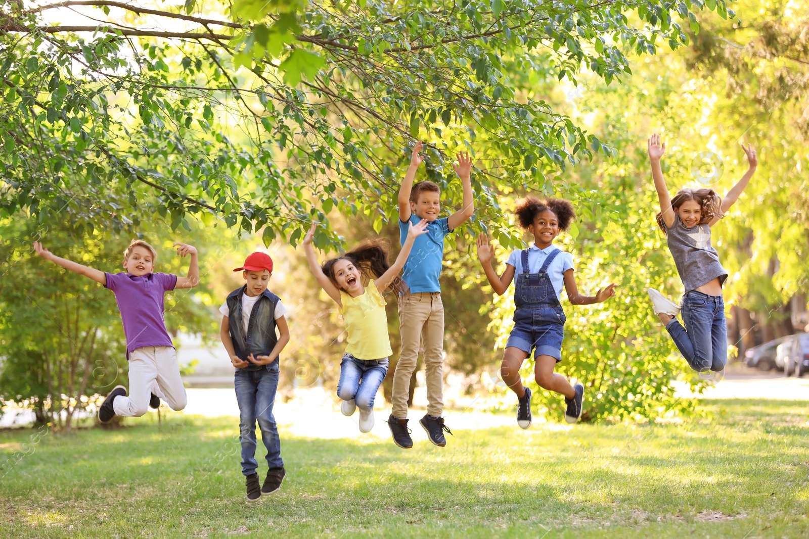 Photo of Cute little children playing together outdoors on sunny day