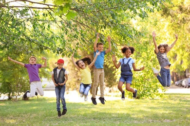 Photo of Cute little children playing together outdoors on sunny day