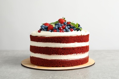 Delicious homemade red velvet cake with fresh berries on white background