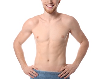 Young man with slim body in towel on white background, closeup