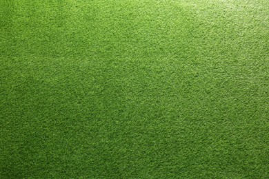 Photo of Green artificial grass as background, top view