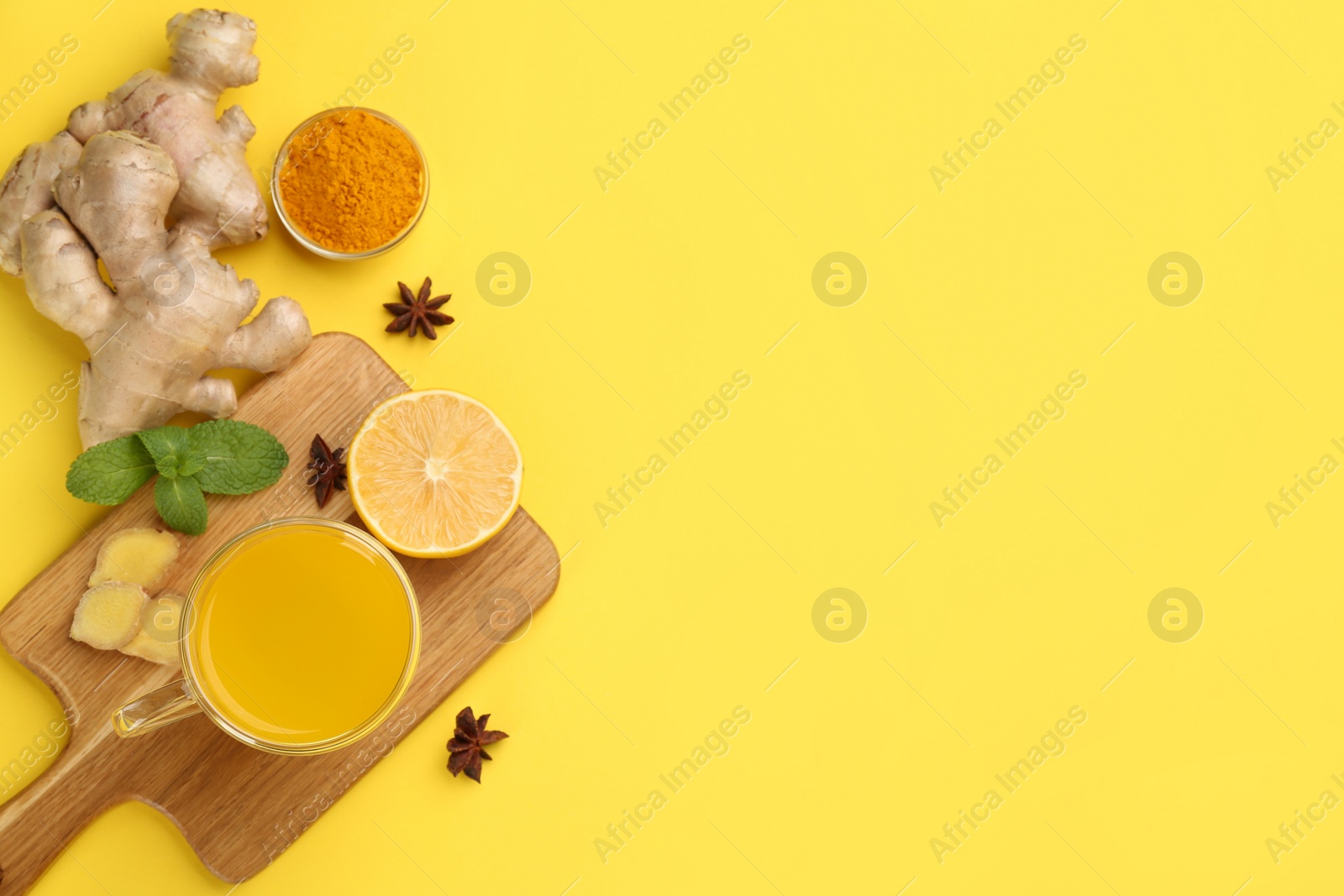 Photo of Flat lay composition with immunity boosting drink on yellow background. Space for text