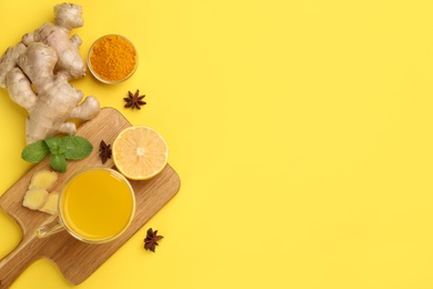 Flat lay composition with immunity boosting drink on yellow background. Space for text