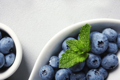 Photo of Flat lay composition with juicy and fresh blueberries on color table, closeup