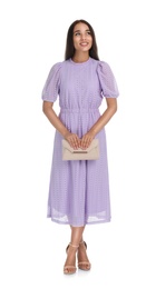 Photo of Young woman wearing stylish lilac dress with elegant clutch on white background