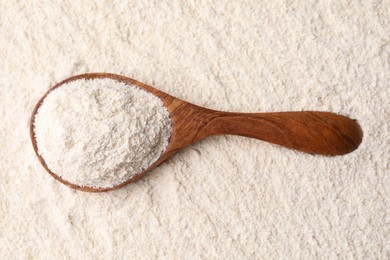 Photo of Quinoa flour and wooden spoon, top view