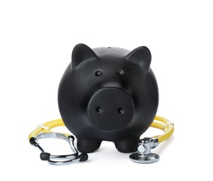 Photo of Piggy bank with stethoscope isolated on white