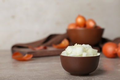 Small bowl with cut onion on table