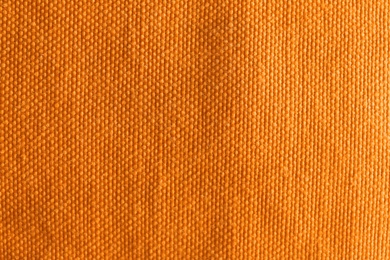 Photo of Orange textured fabric as background, top view