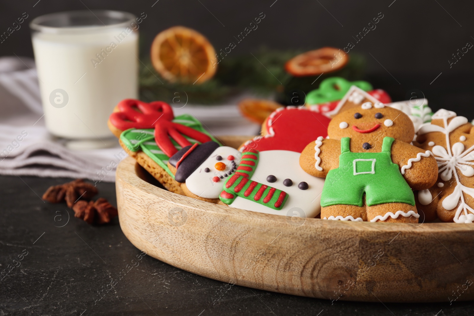 Photo of Tasty Christmas cookies on black table, closeup