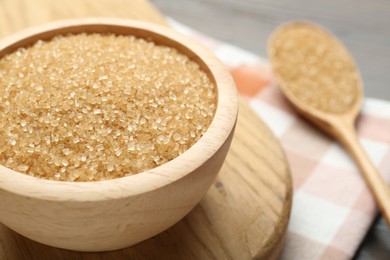 Photo of Brown sugar in bowl on table, closeup