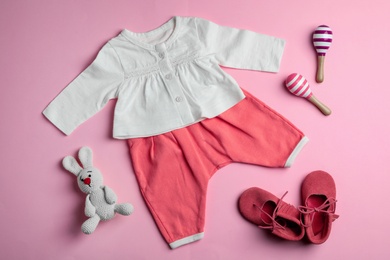 Photo of Flat lay composition with cute clothes on color background. Baby accessories