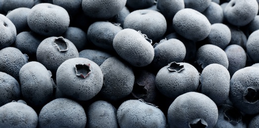 Photo of Tasty frozen blueberries as background, closeup view