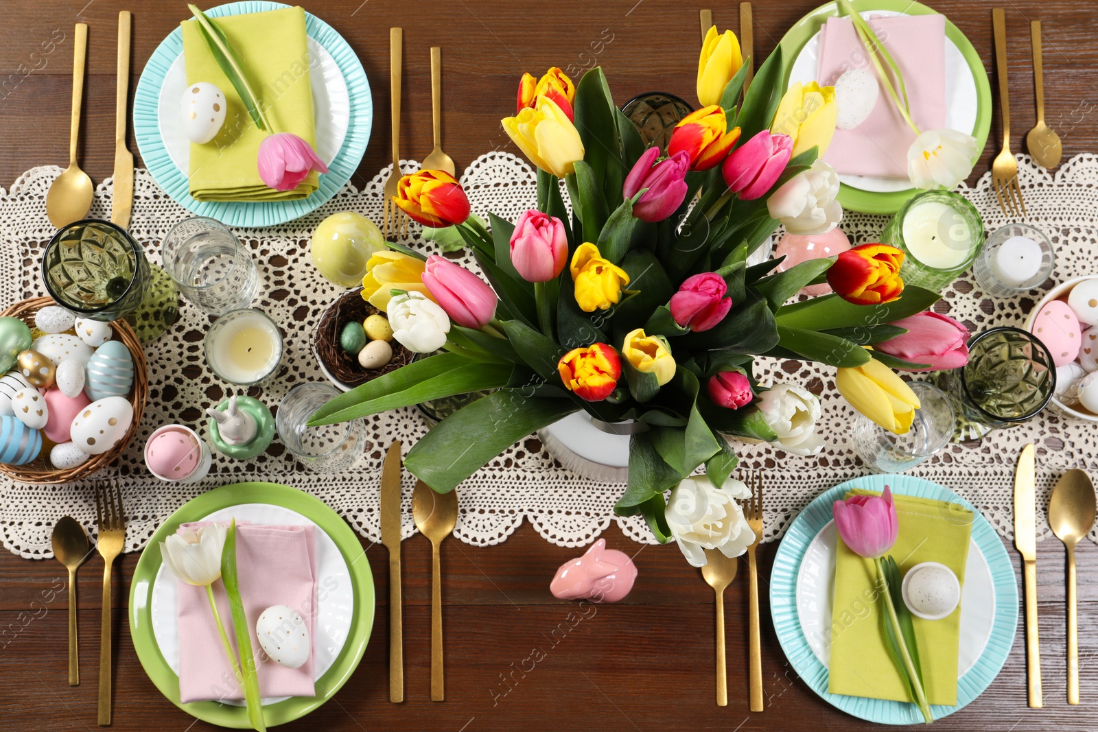 Photo of Festive table setting with beautiful flowers, flat lay. Easter celebration