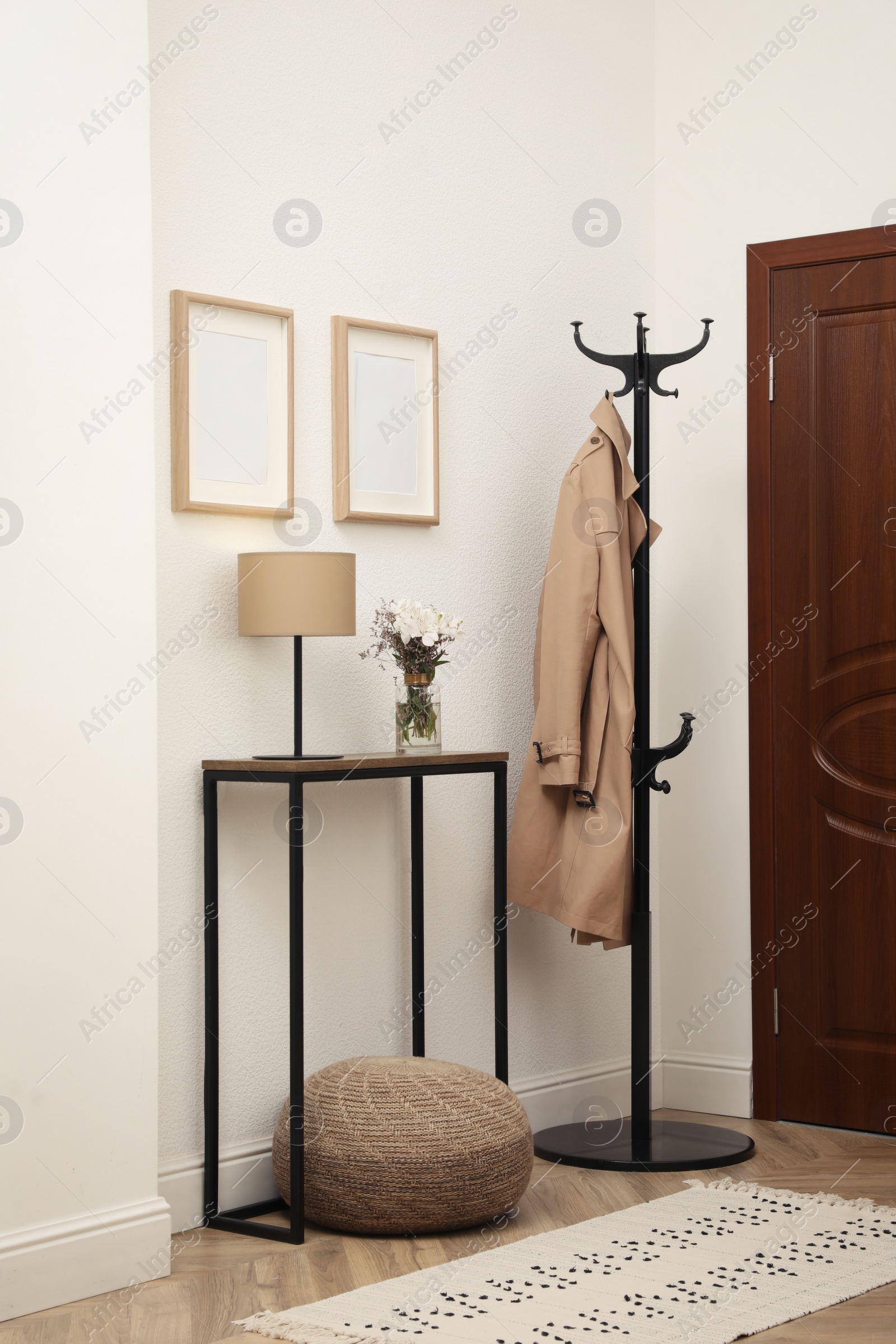 Photo of Bouquet with alstroemeria flowers on console table in modern hallway. Interior design