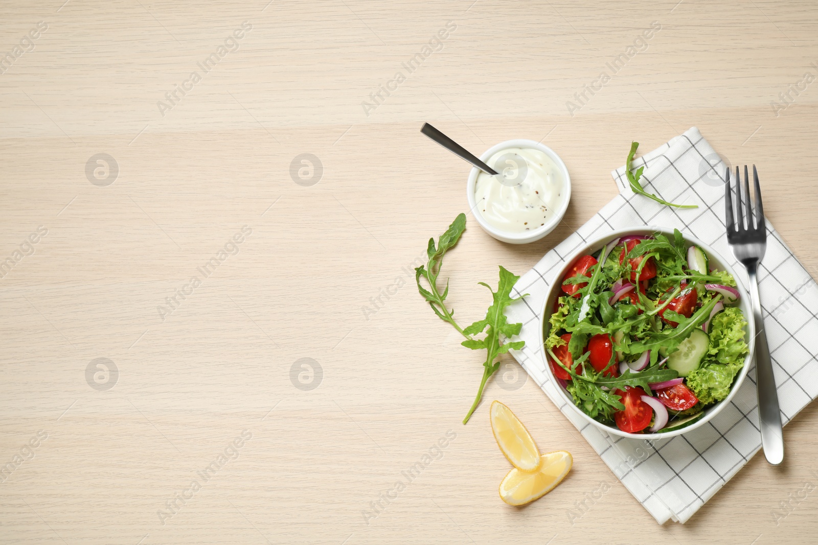 Photo of Delicious salad with arugula and vegetables on wooden table, flat lay. Space for text