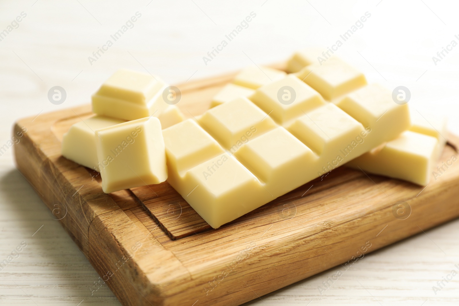 Photo of Delicious white chocolate on wooden table, closeup