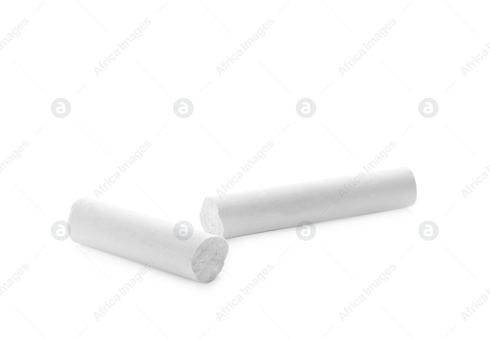 Photo of Small pieces of chalk on white background