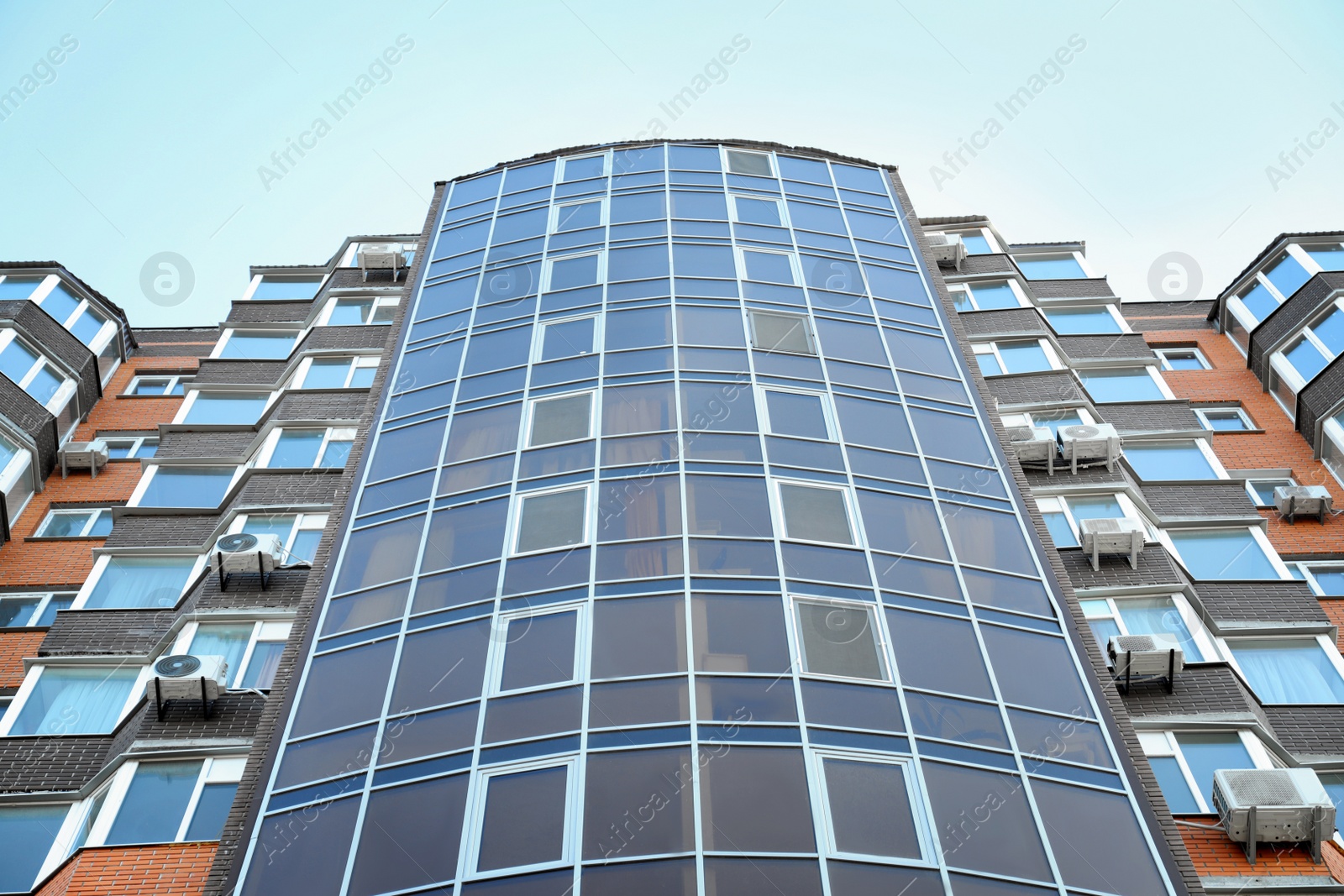 Photo of Modern building with tinted windows, low angle view. Urban architecture