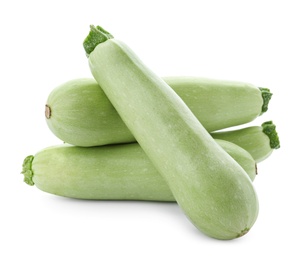 Fresh ripe zucchini squashes on white background