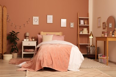 Teenage girl's bedroom interior with stylish furniture and beautiful decor elements