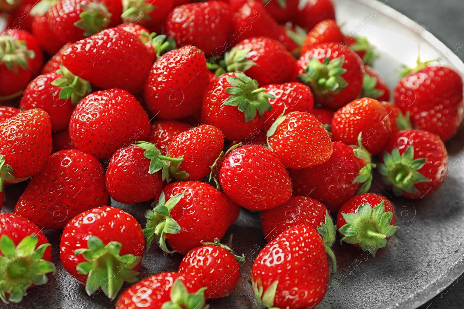 Photo of Plate with red ripe strawberries, closeup view