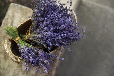 Wicker basket with beautiful lavender flowers outdoors, top view