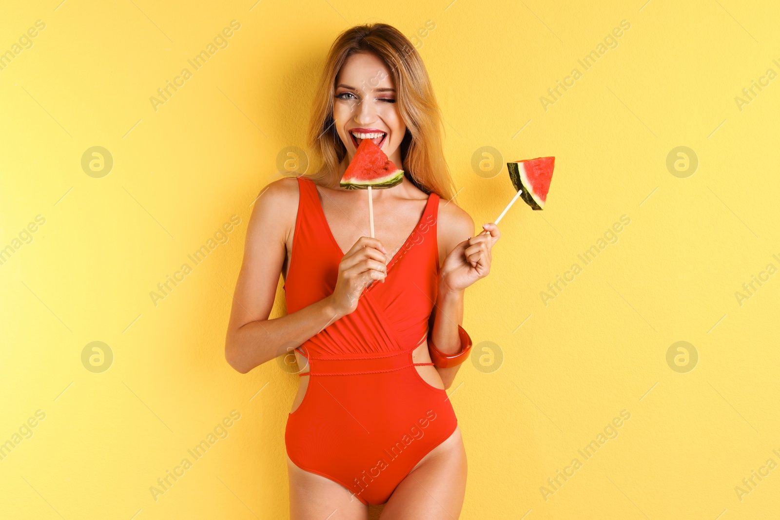 Photo of Pretty young woman with juicy watermelon on color background