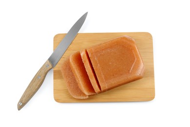 Photo of Delicious sweet quince paste and knife isolated on white, top view