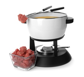 Photo of Fondue pot with oil and raw meat on white background