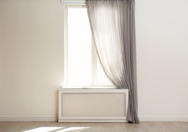 Photo of Light room with window and open curtains. Home interior