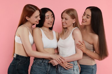 Photo of Portrait of beautiful young women on pink background