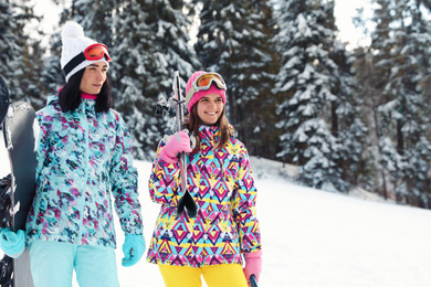 Photo of Group of friends with equipment in snowy mountains. Winter vacation