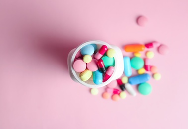 Photo of Bottle with pills on color background