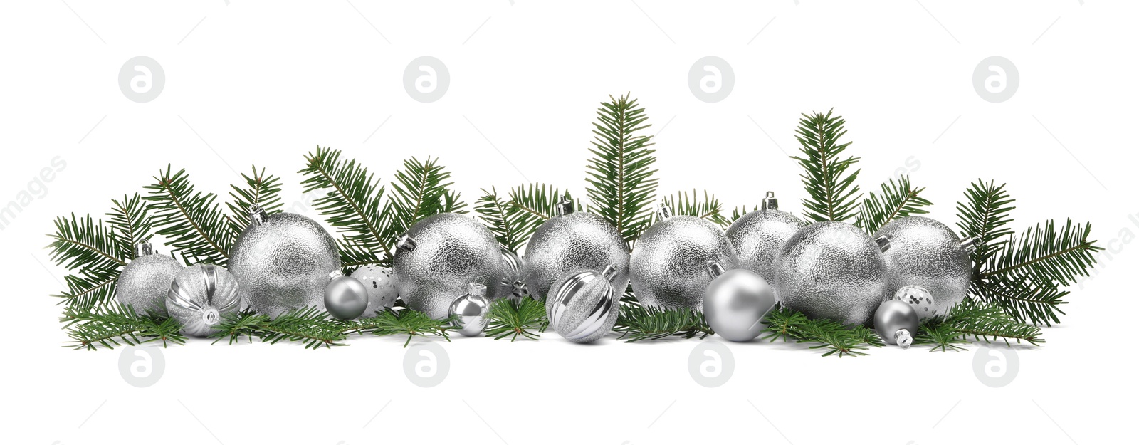 Photo of Many silver Christmas balls and fir twigs isolated on white