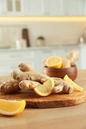 Photo of Fresh lemon and ginger on wooden table indoors, space for text