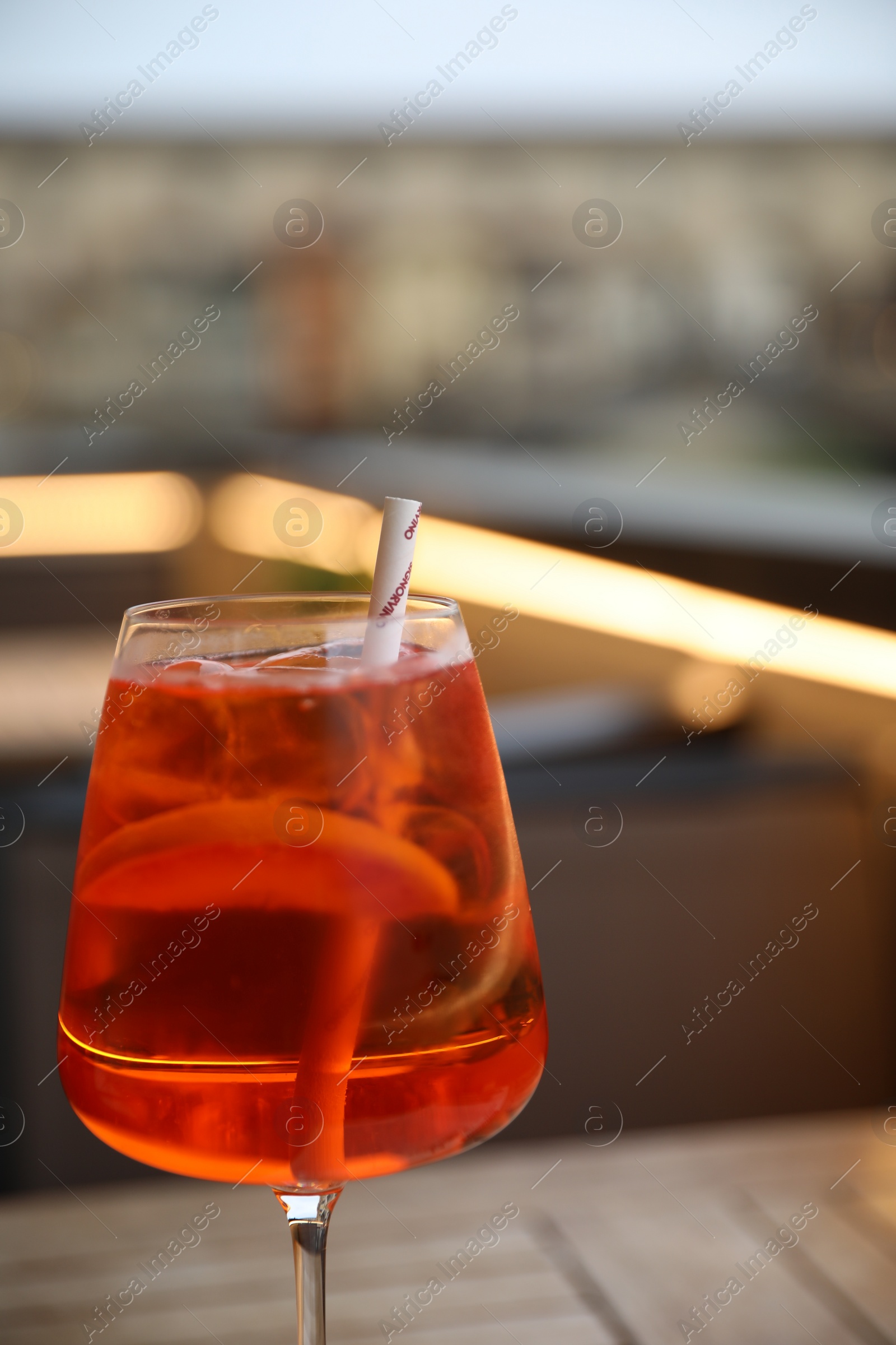 Photo of Alcohol drink in glass on table outdoors, closeup
